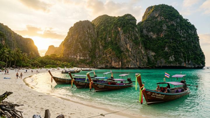 Iconic limestone karst cliffs and traditional longtail boats in Southern Thailand